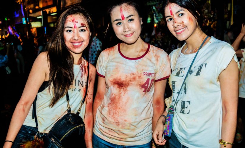 Three young woman enjoying Dussehra festival in Bangkok, Thailand